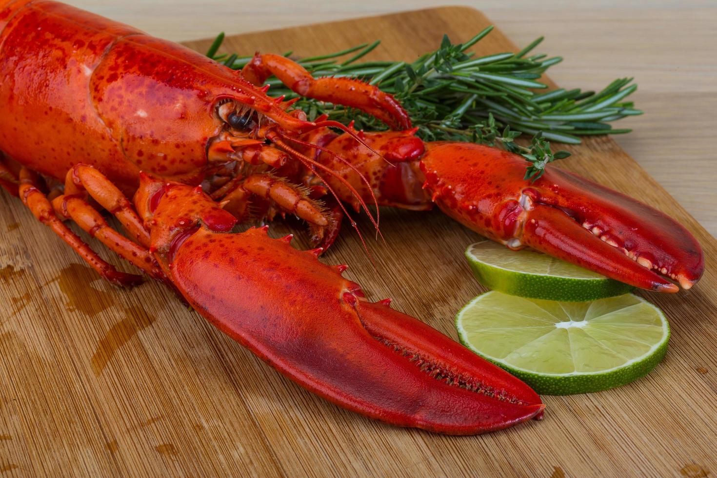 Red boiled lobster on wooden board and wooden background photo