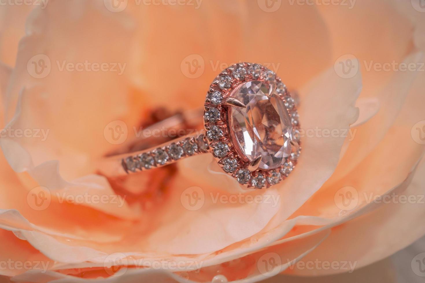 pink diamond ring on rose flower background photo