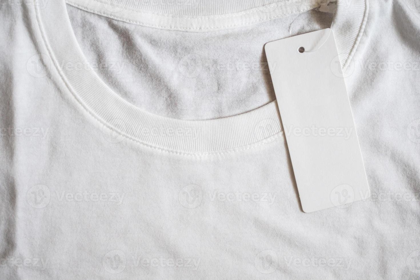 Blank price tag label on white t-shirt photo