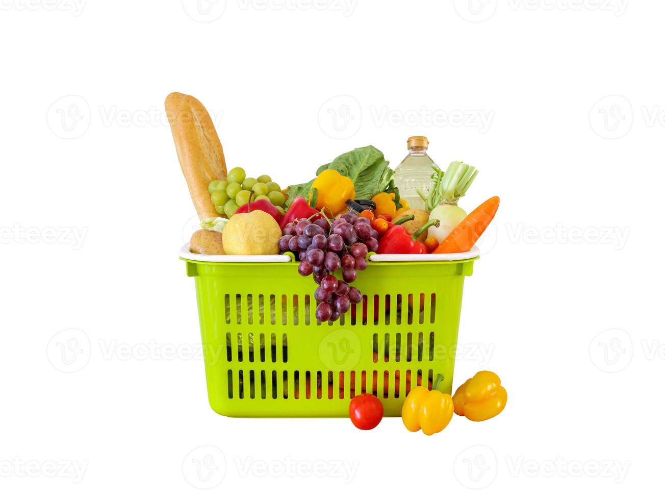 Fresh fruits and vegetables grocery product in green shopping basket isolated on white background photo