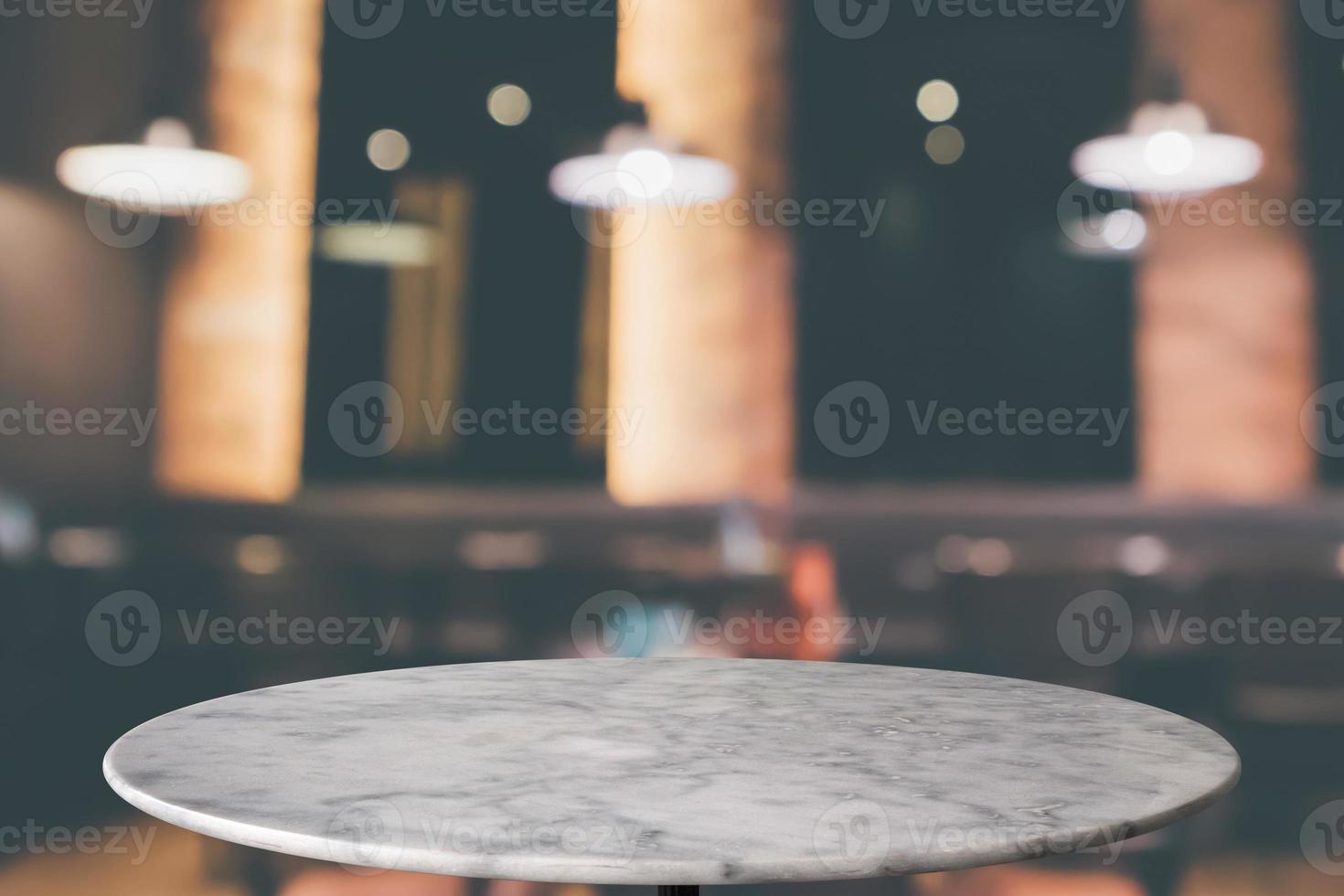 round marble table top with cafe restaurant bokeh lights abstract background for montage product display photo
