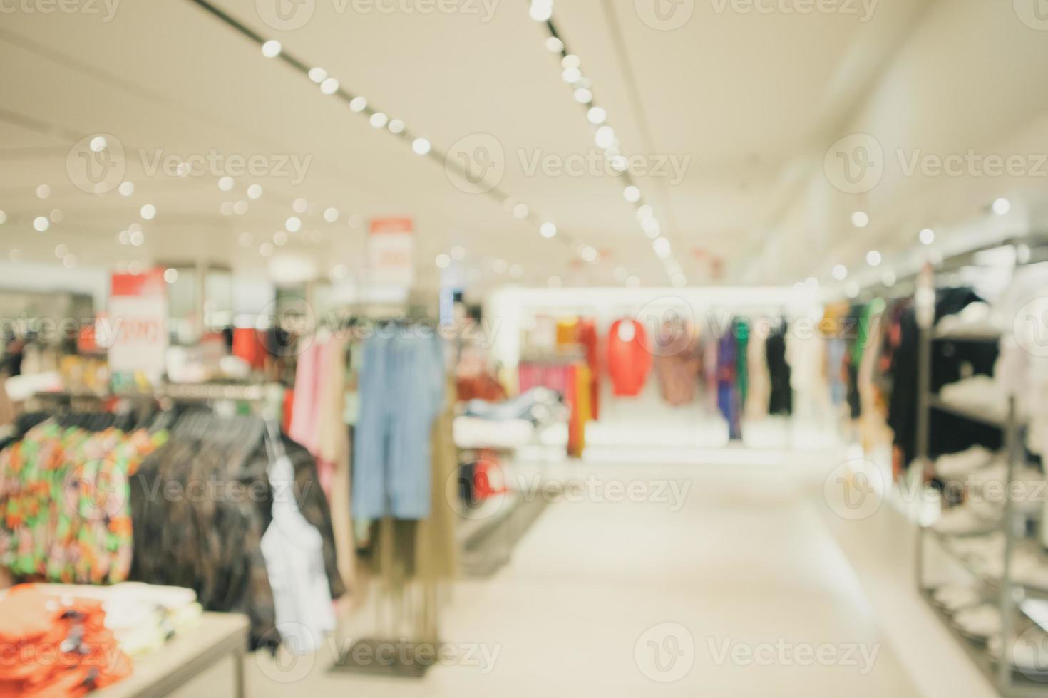 woman fashionable boutique clothing store window display in shopping mall blur defocused background photo