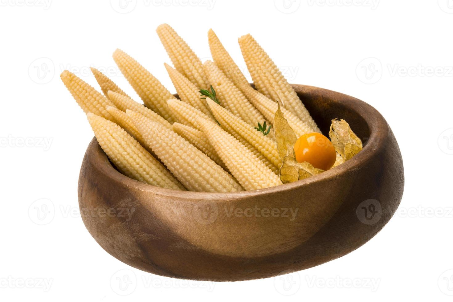 Baby corn in a bowl on white background photo
