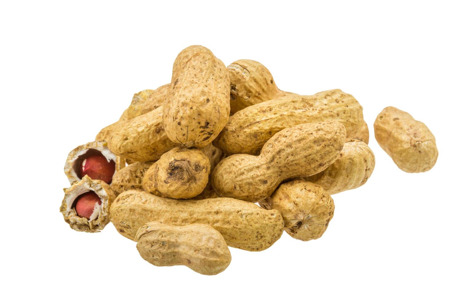 Peanut heap on white background photo