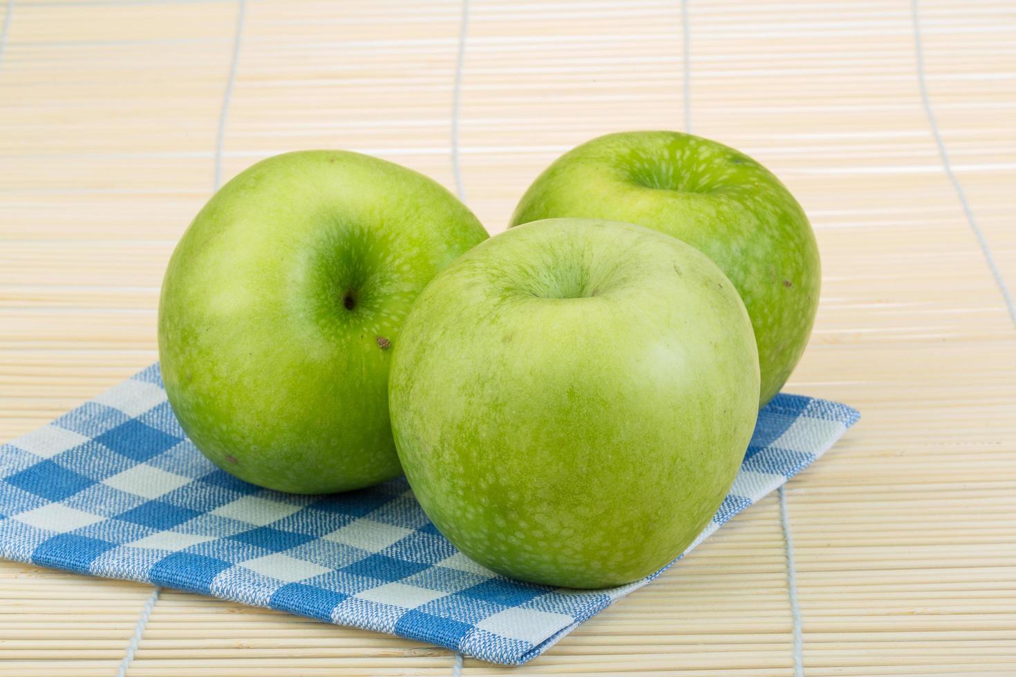 Green apple on wooden background photo