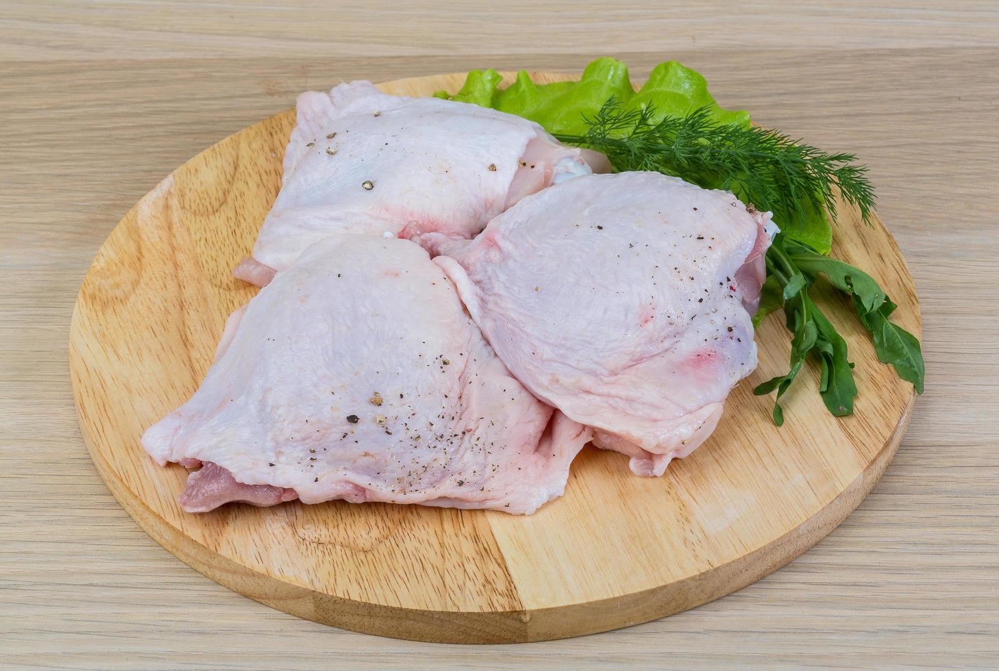 Raw chicken thighs photo