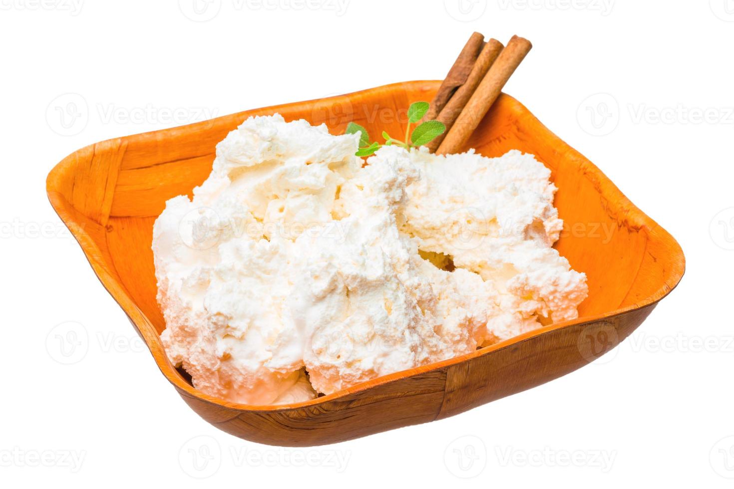 Cottage cheese in a bowl on white background photo