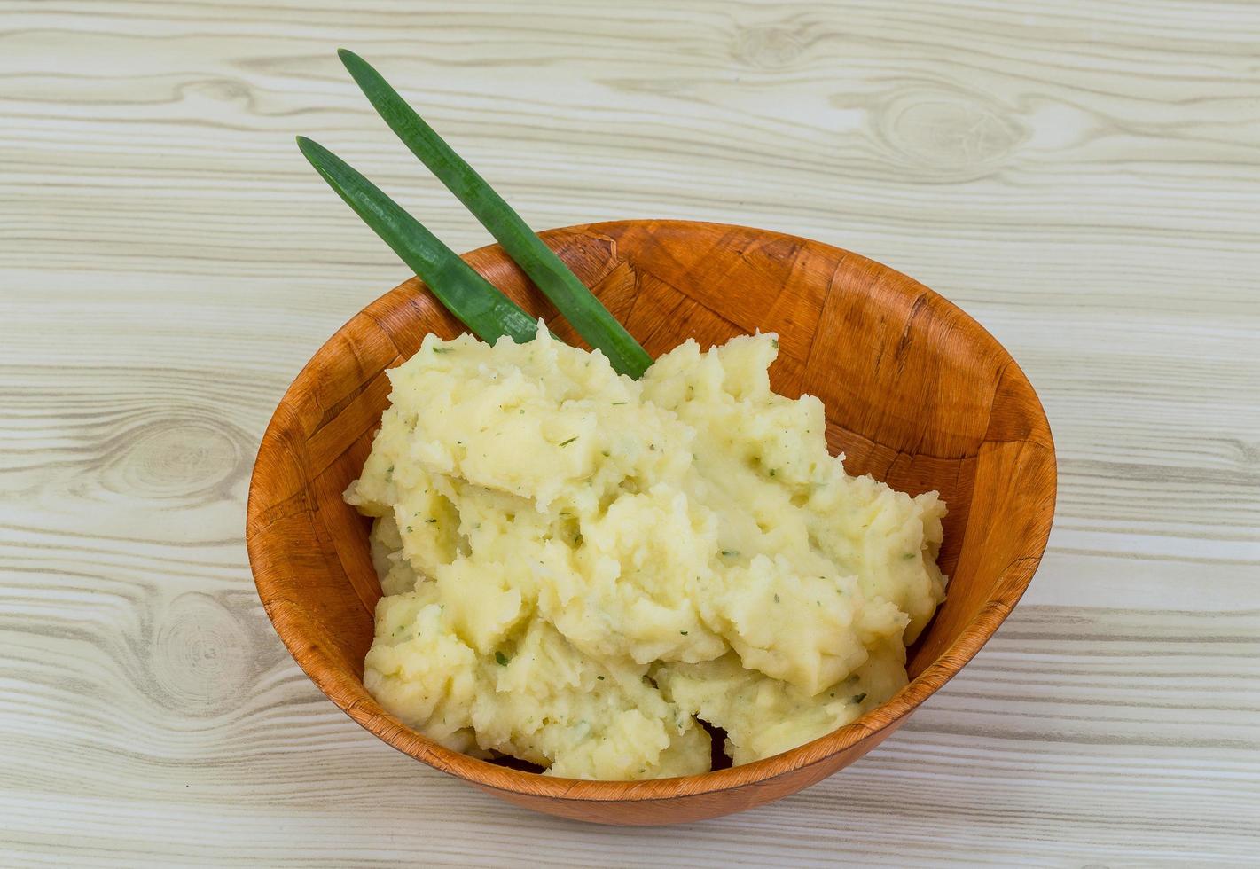 Mash potato in a bowl on wooden background photo