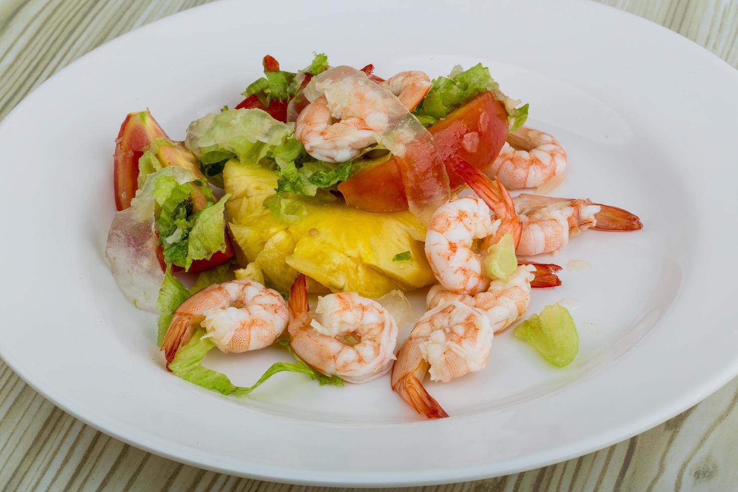 Shrimps with aloe vera salad on the plate and wooden background photo