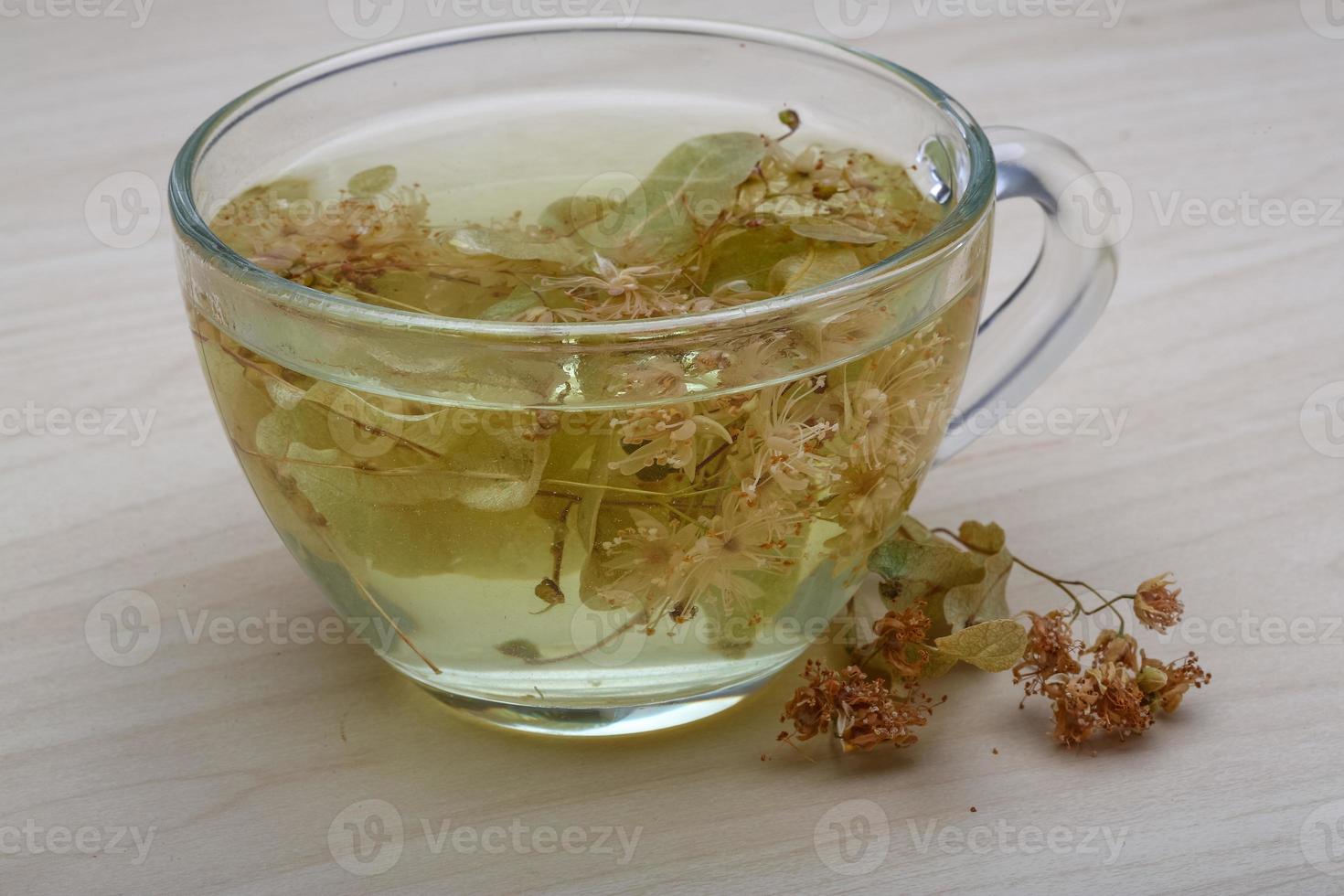 Linden tea on wooden background photo