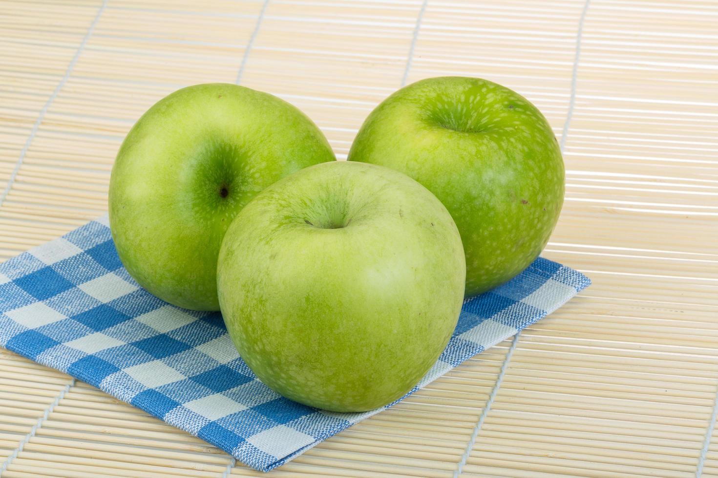 Green apple on wooden background photo