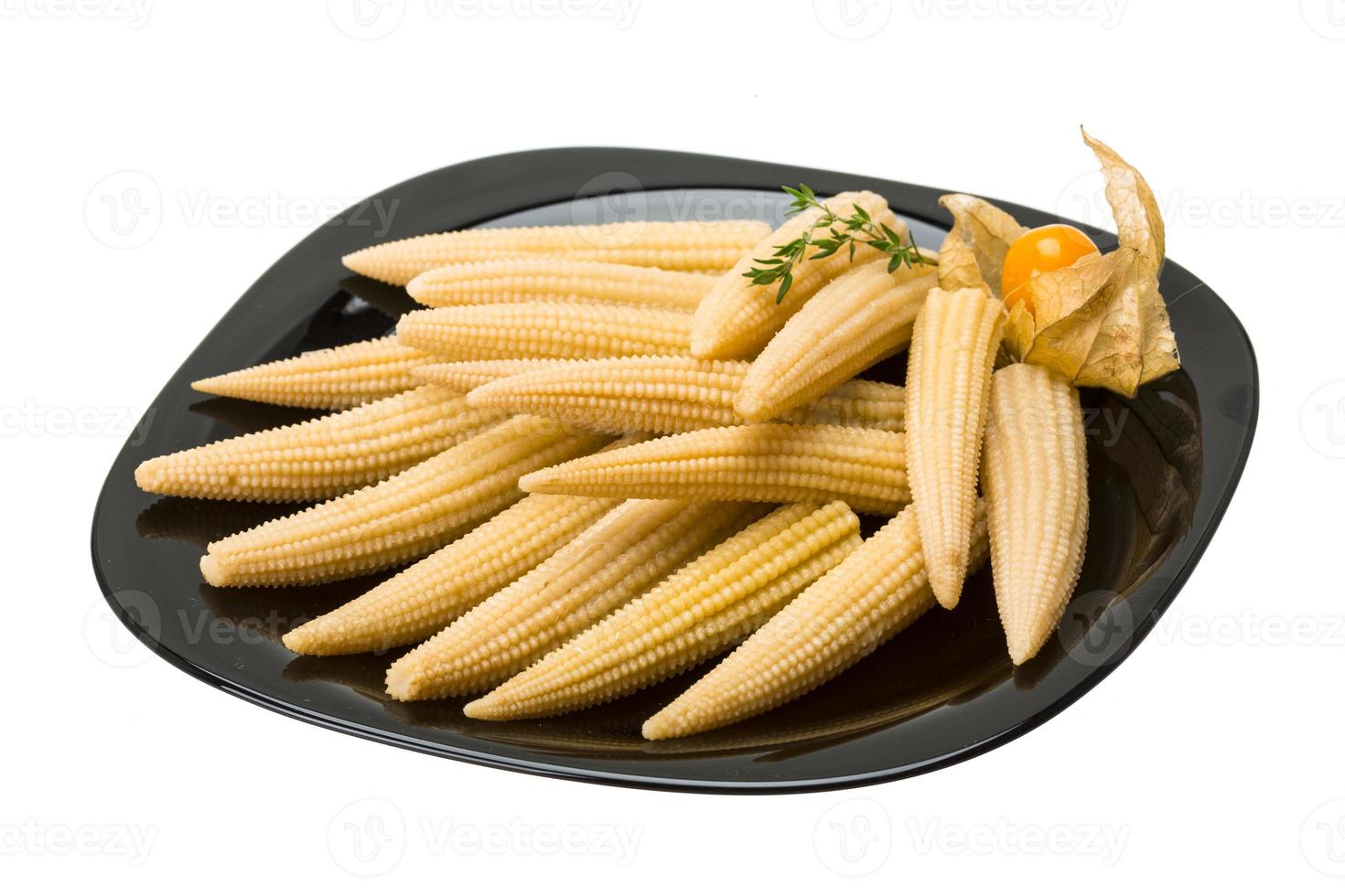 Baby corn on the plate and white background photo