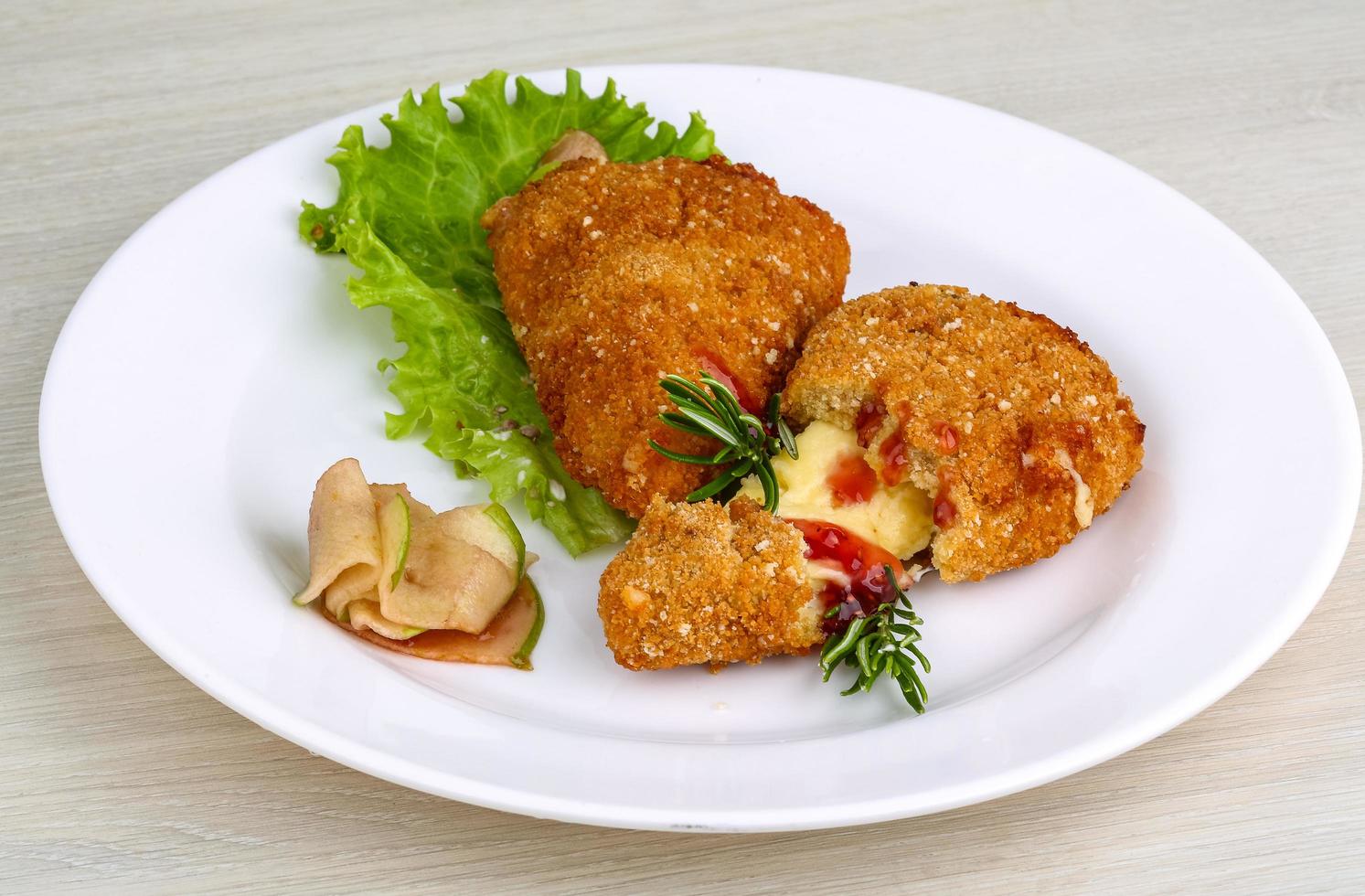 Fried cheese on the plate and wooden background photo
