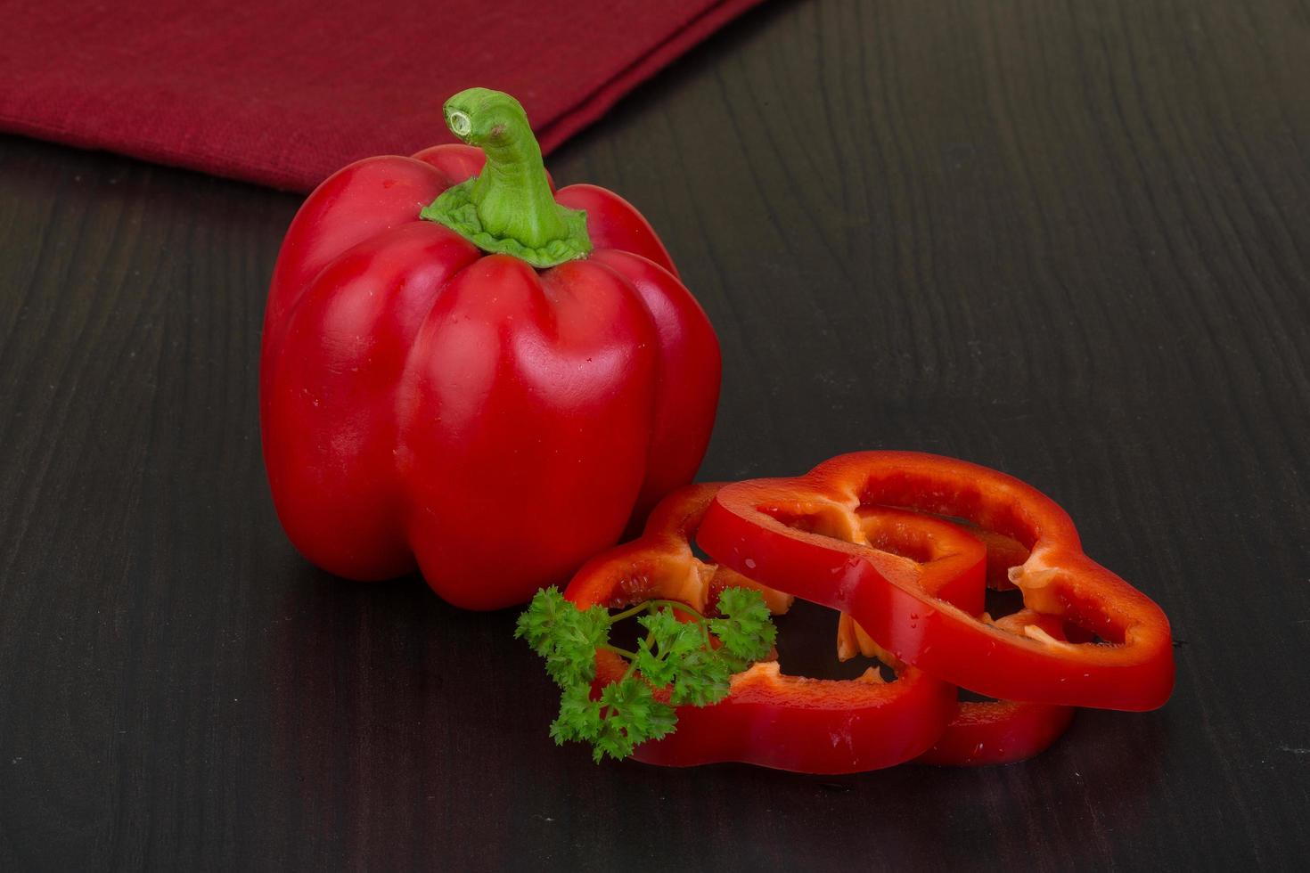 Red pepper on wooden background photo