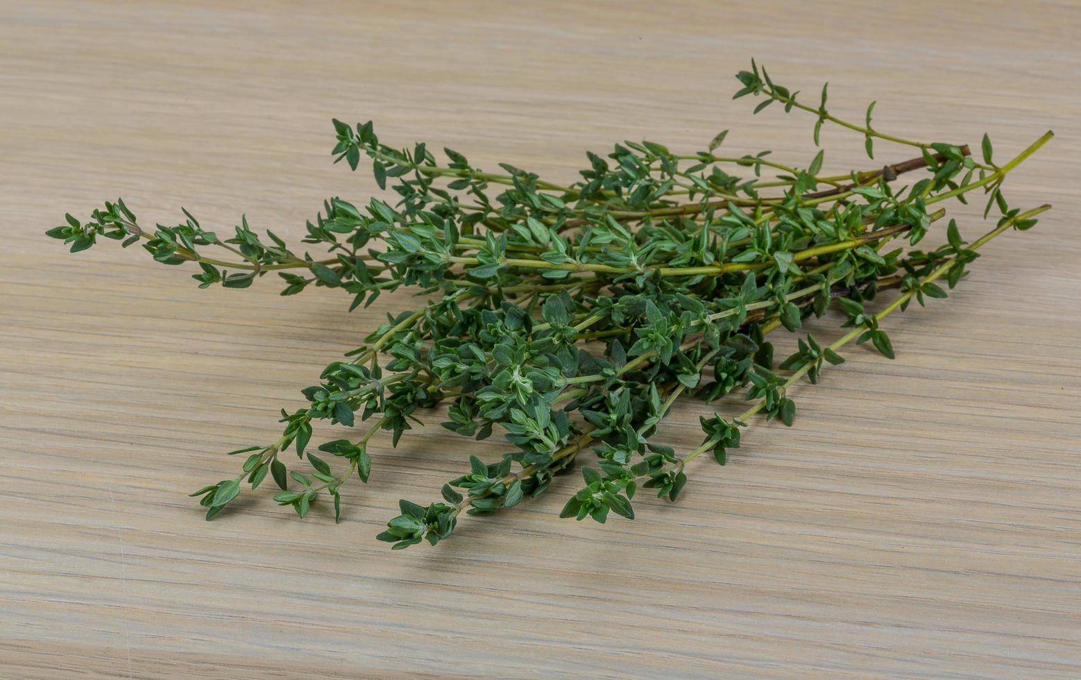 Fresh thyme on wooden background photo