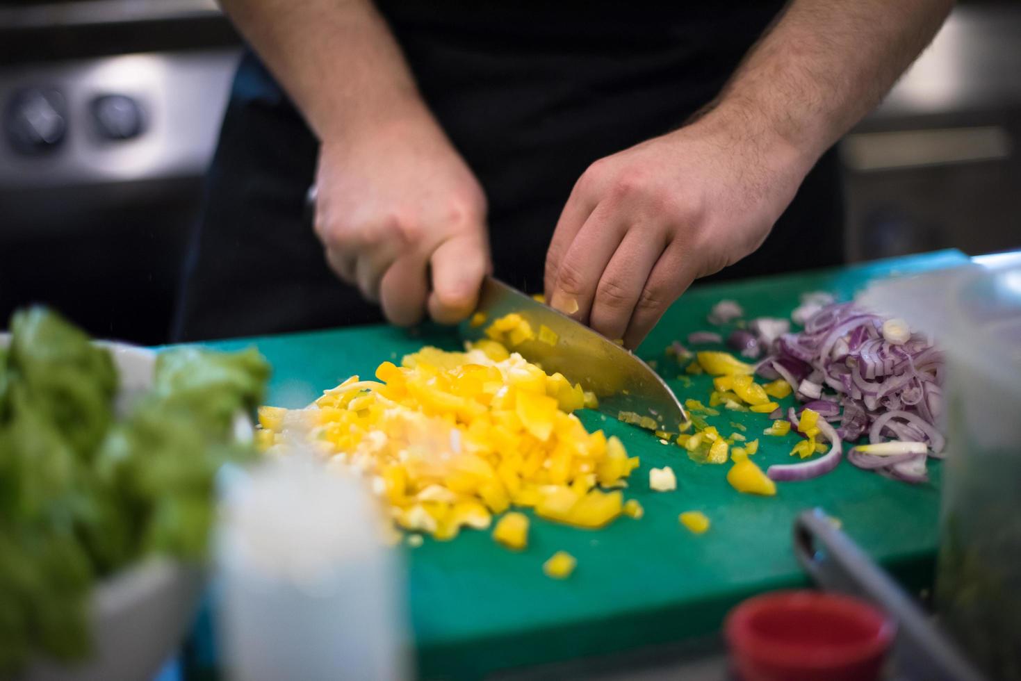 Chef hands cutting fresh and delicious vegetables photo