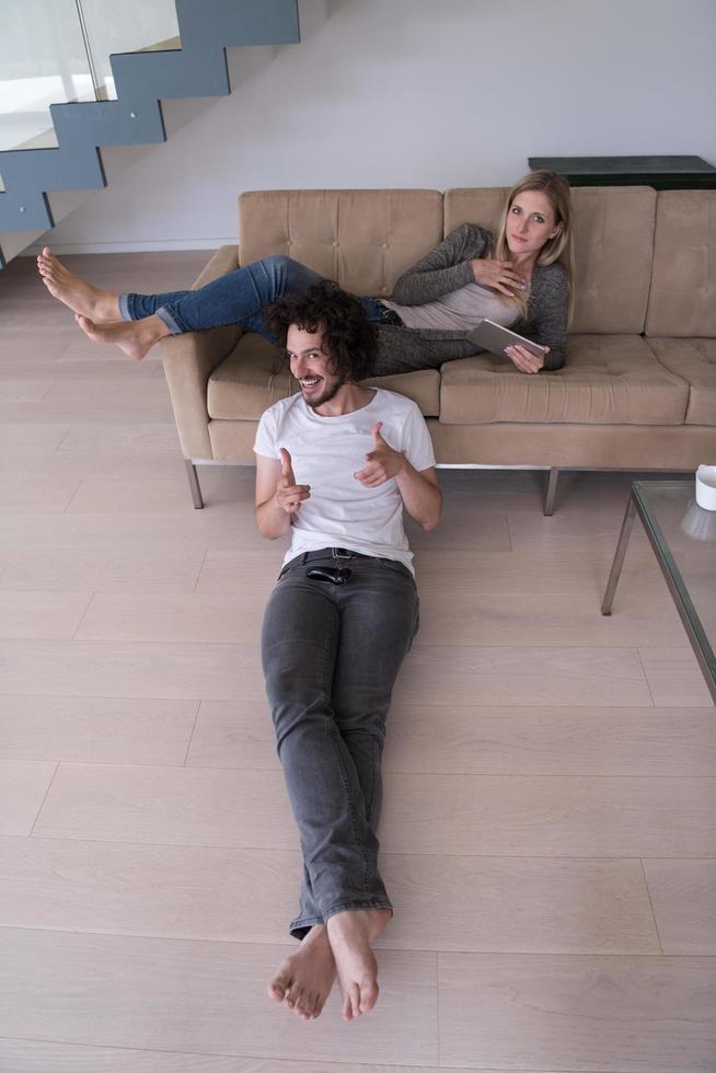 young couple relaxes in the living room photo