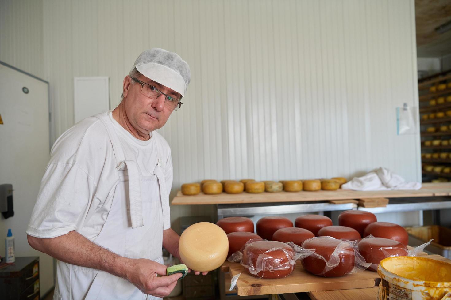 Cheese maker at local  production factory photo