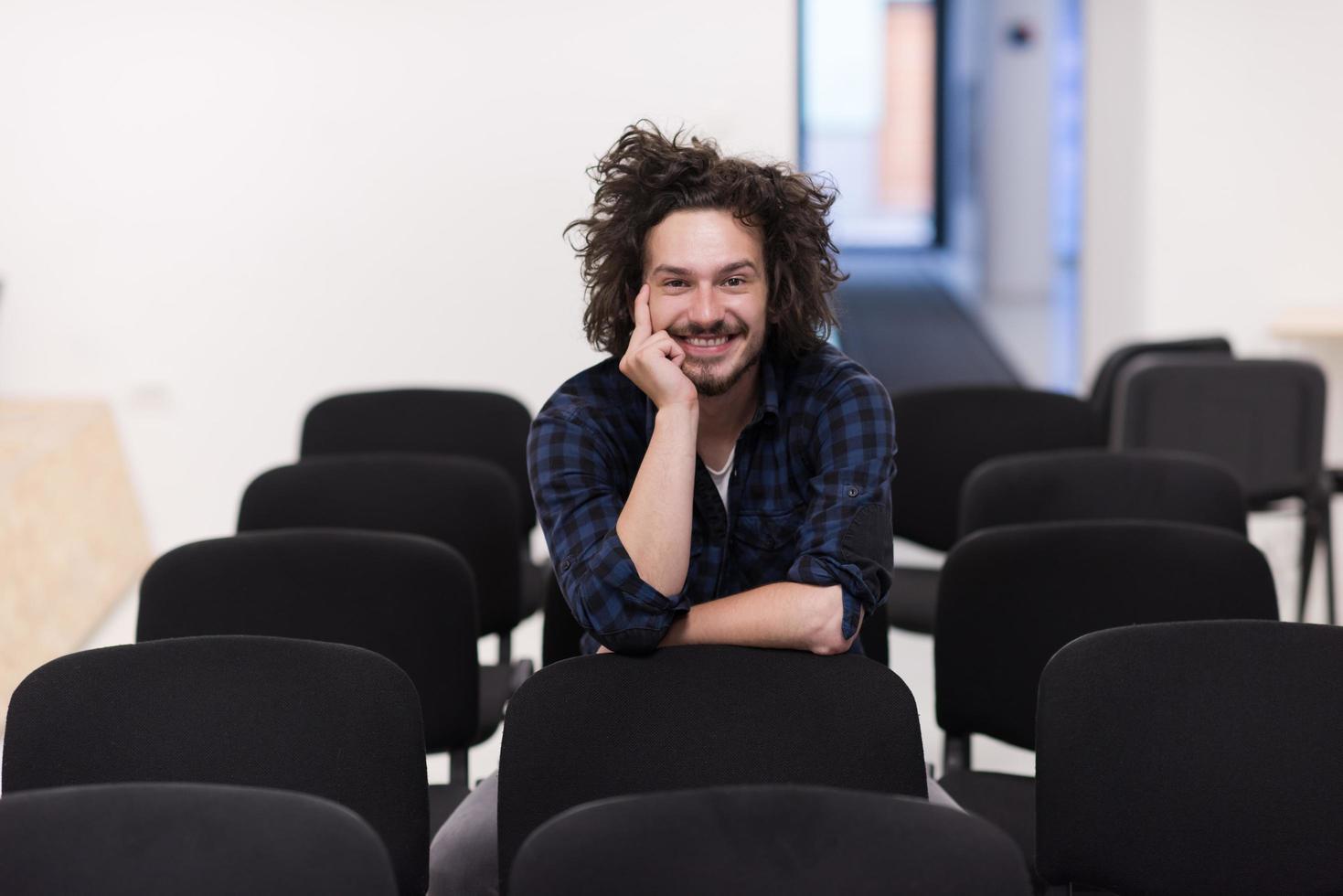 A student sits alone  in a classroom photo