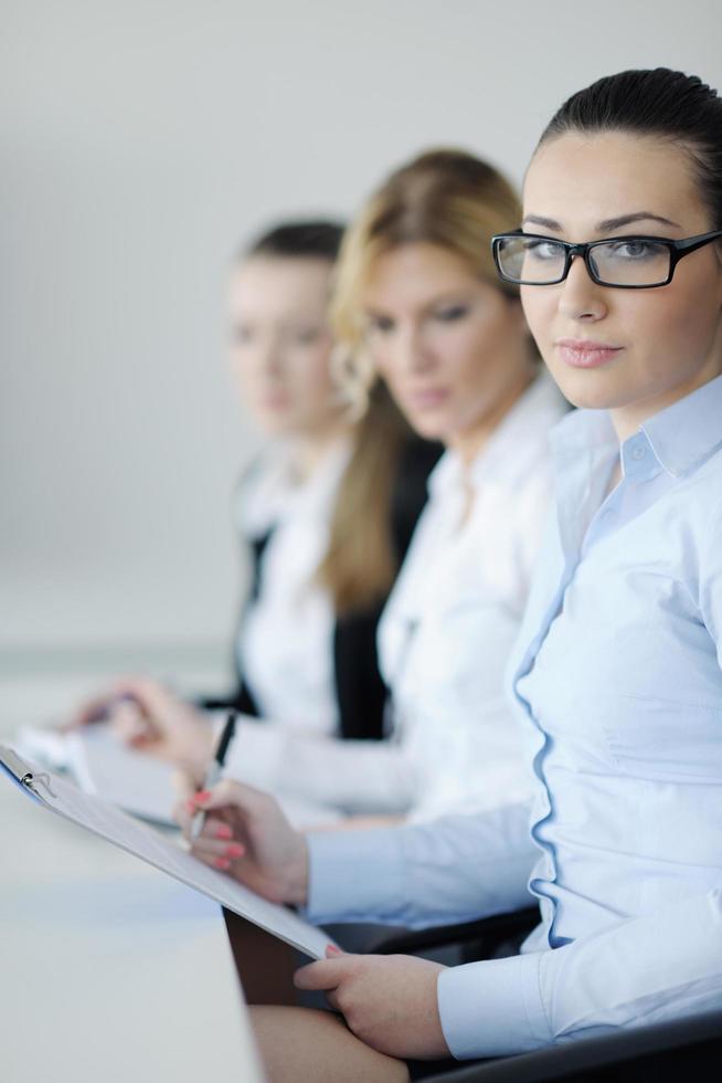 business woman standing with her staff in background photo