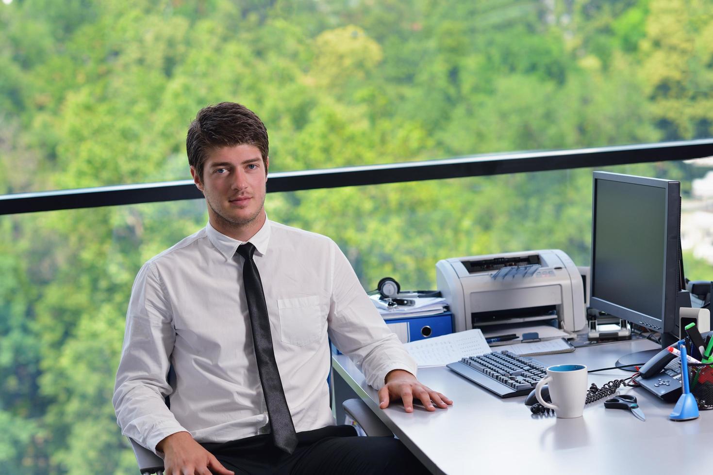 happy young business man at office photo