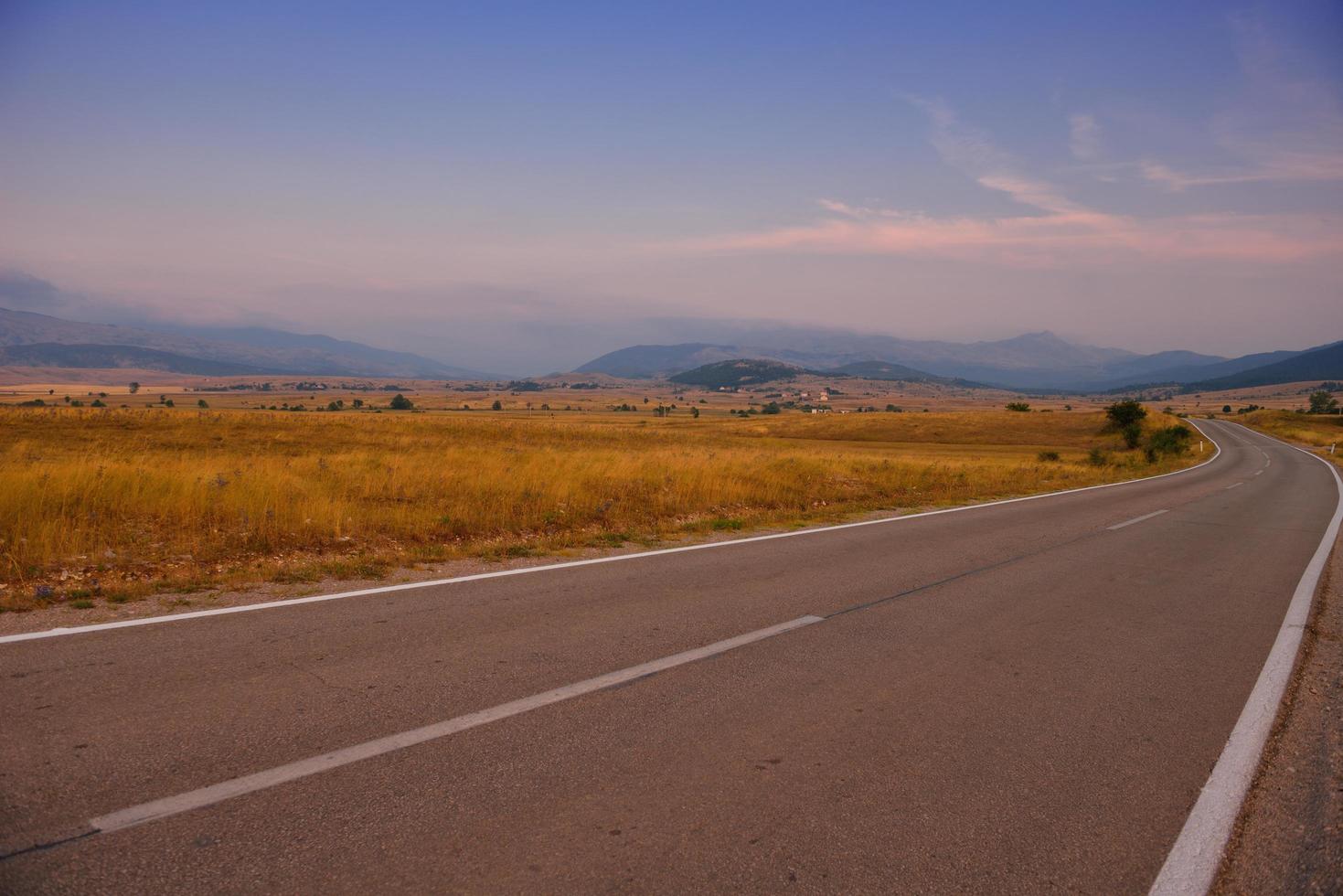 road through the green field photo