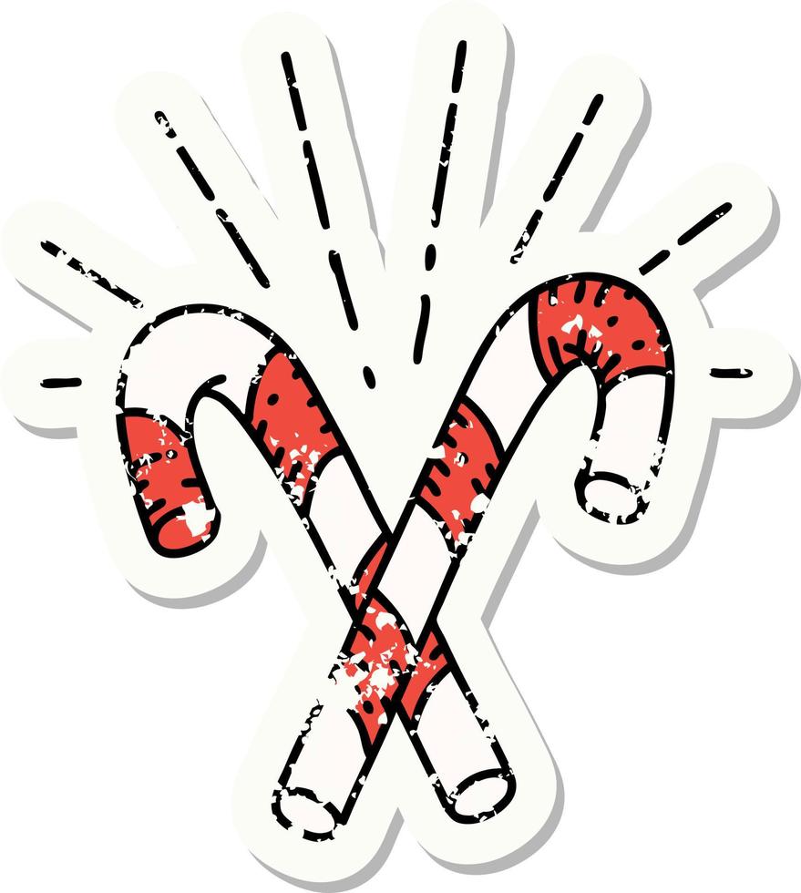 worn old sticker of a tattoo style candy canes vector