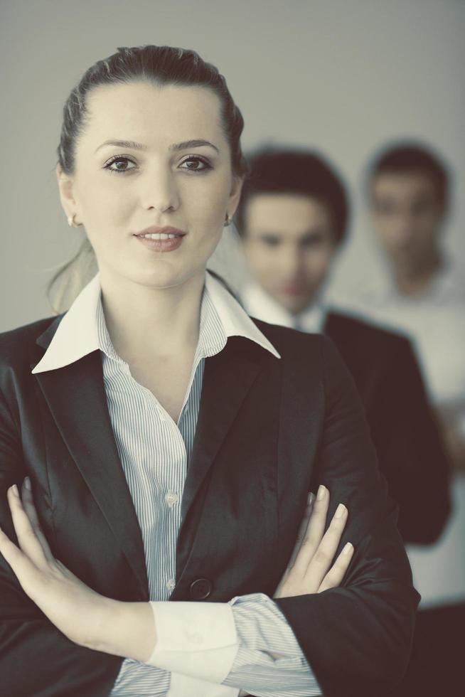 business woman standing with her staff in background photo