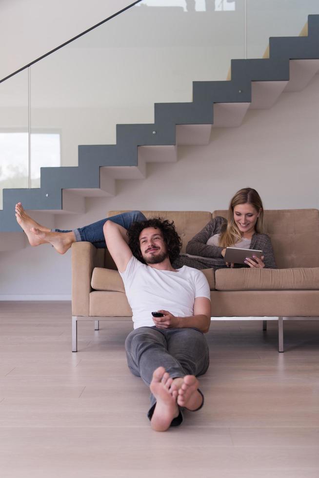 young couple relaxes in the living room photo