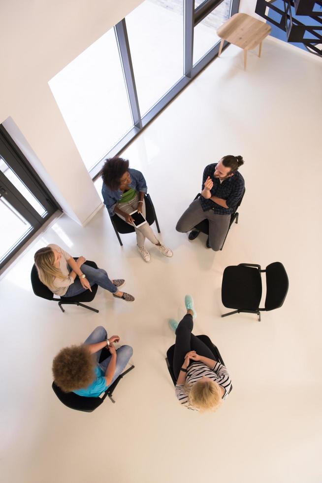 Multiethnic startup business team on meeting  top view photo