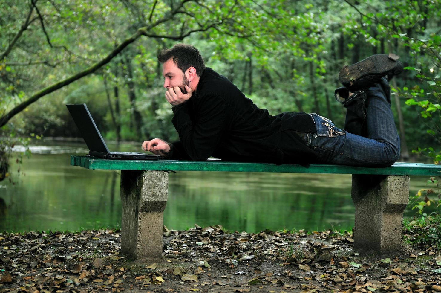 young businessman working on laptop outdoor photo