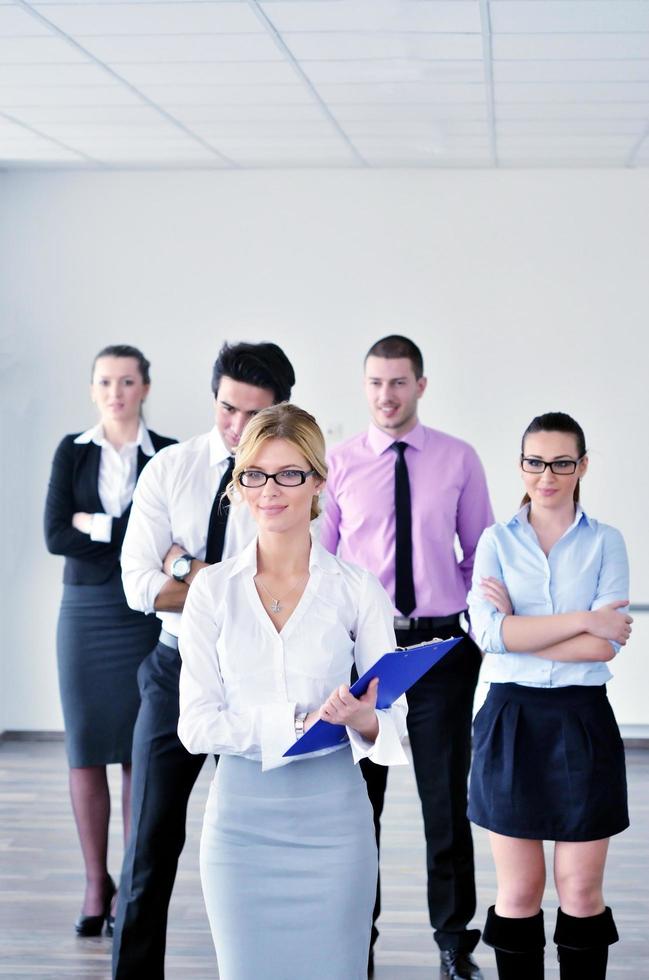 business woman standing with her staff in background photo