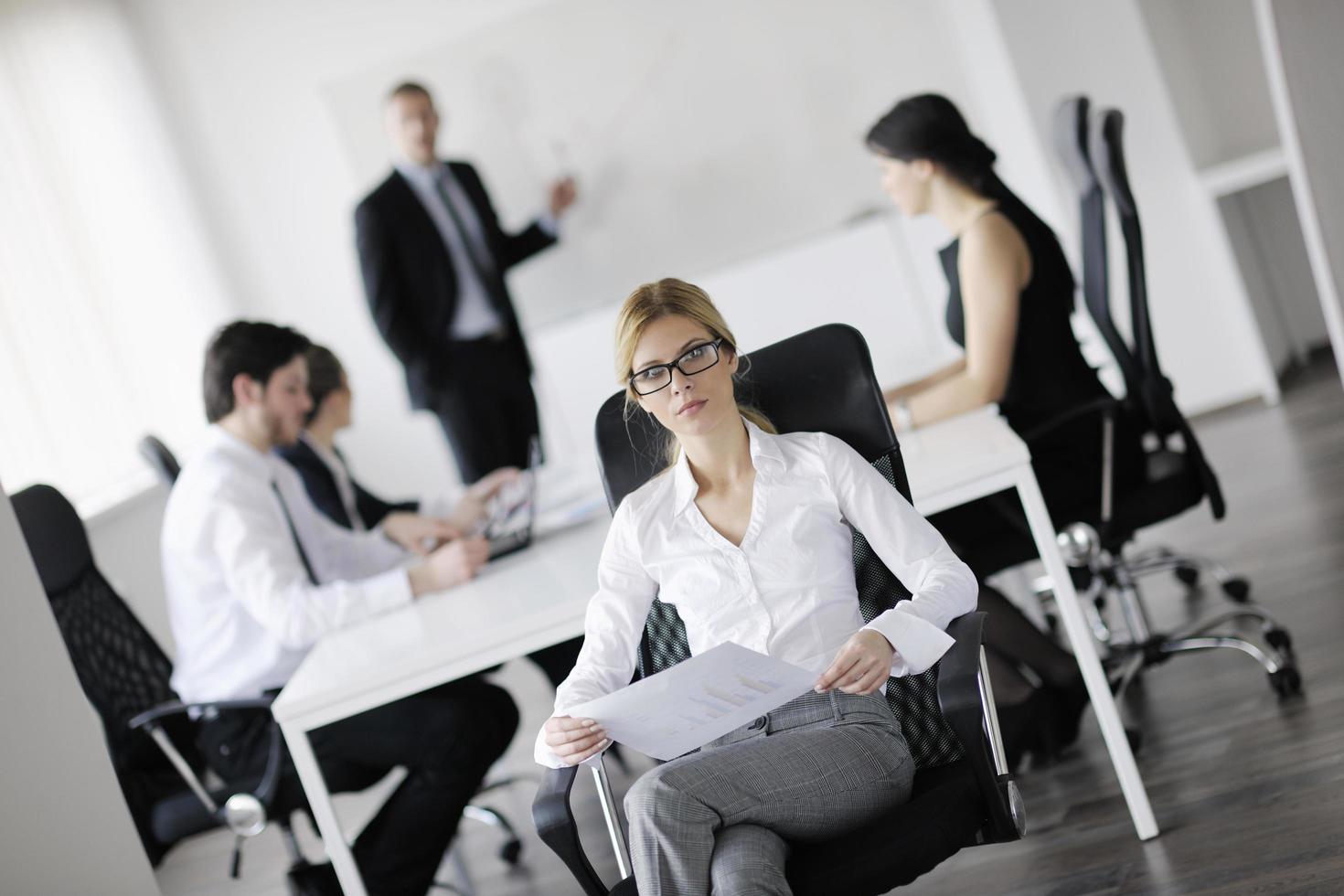 business woman with her staff in background photo