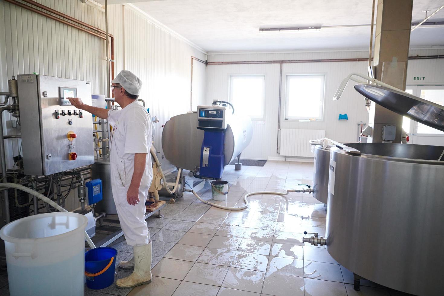 Cheese production cheesemaker  working in factory photo