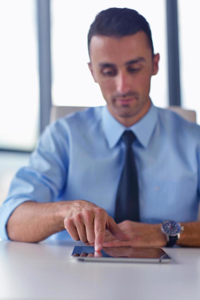 business man using tablet compuer at office photo
