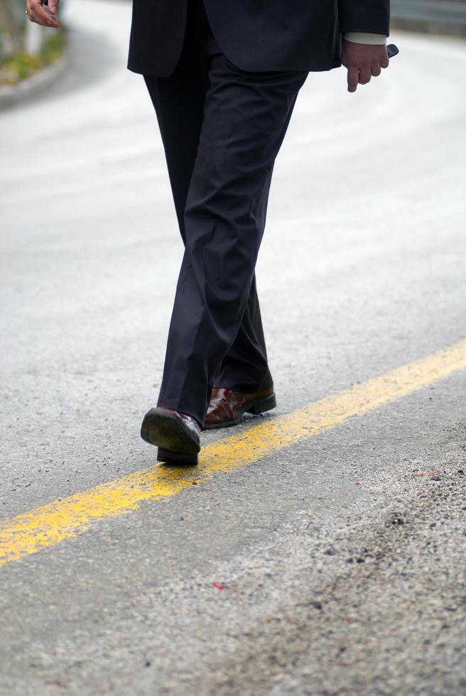 .businessman walking on yellow line photo