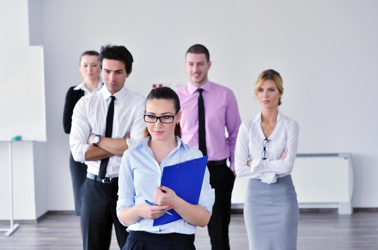 business woman standing with her staff in background photo