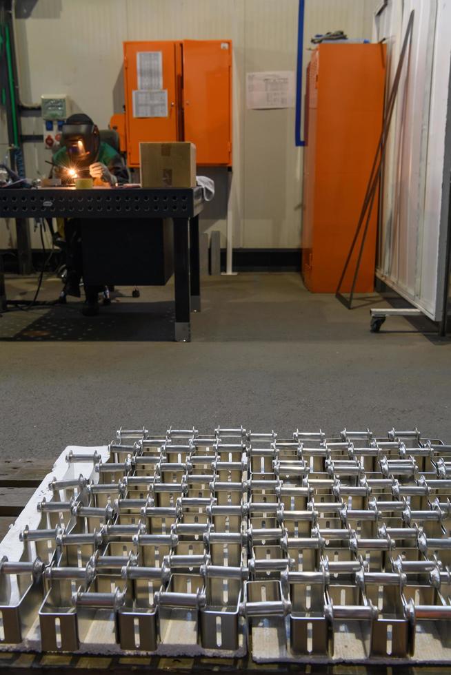 The first phase of metal and aluminum processing. Processed products from CNC machines stacked on a pallet in a large modern factory photo