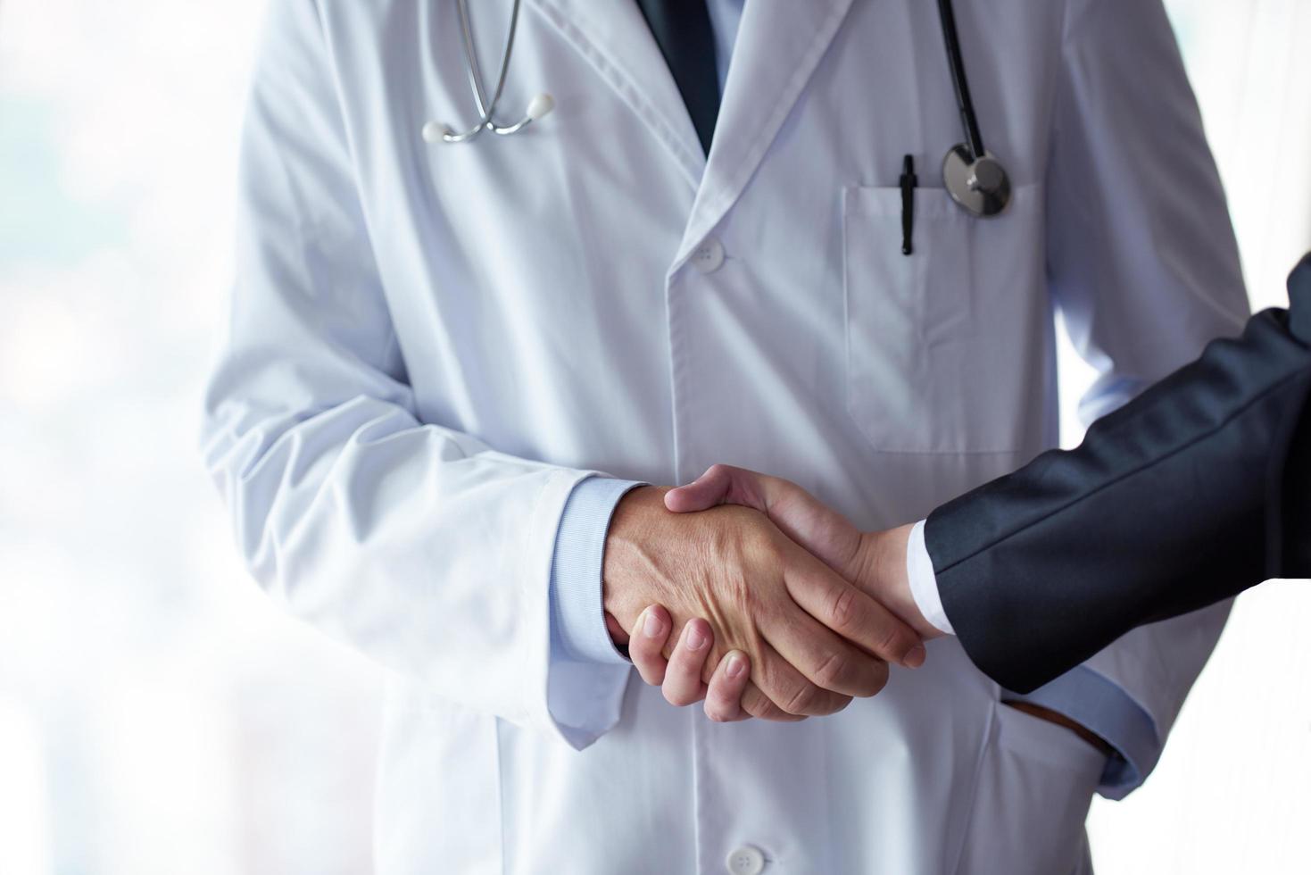 doctor handshake with a patient photo