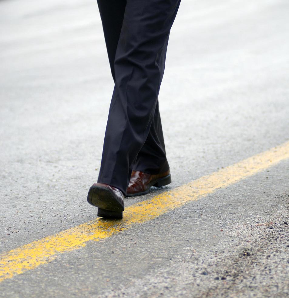 .businessman walking on yellow line photo