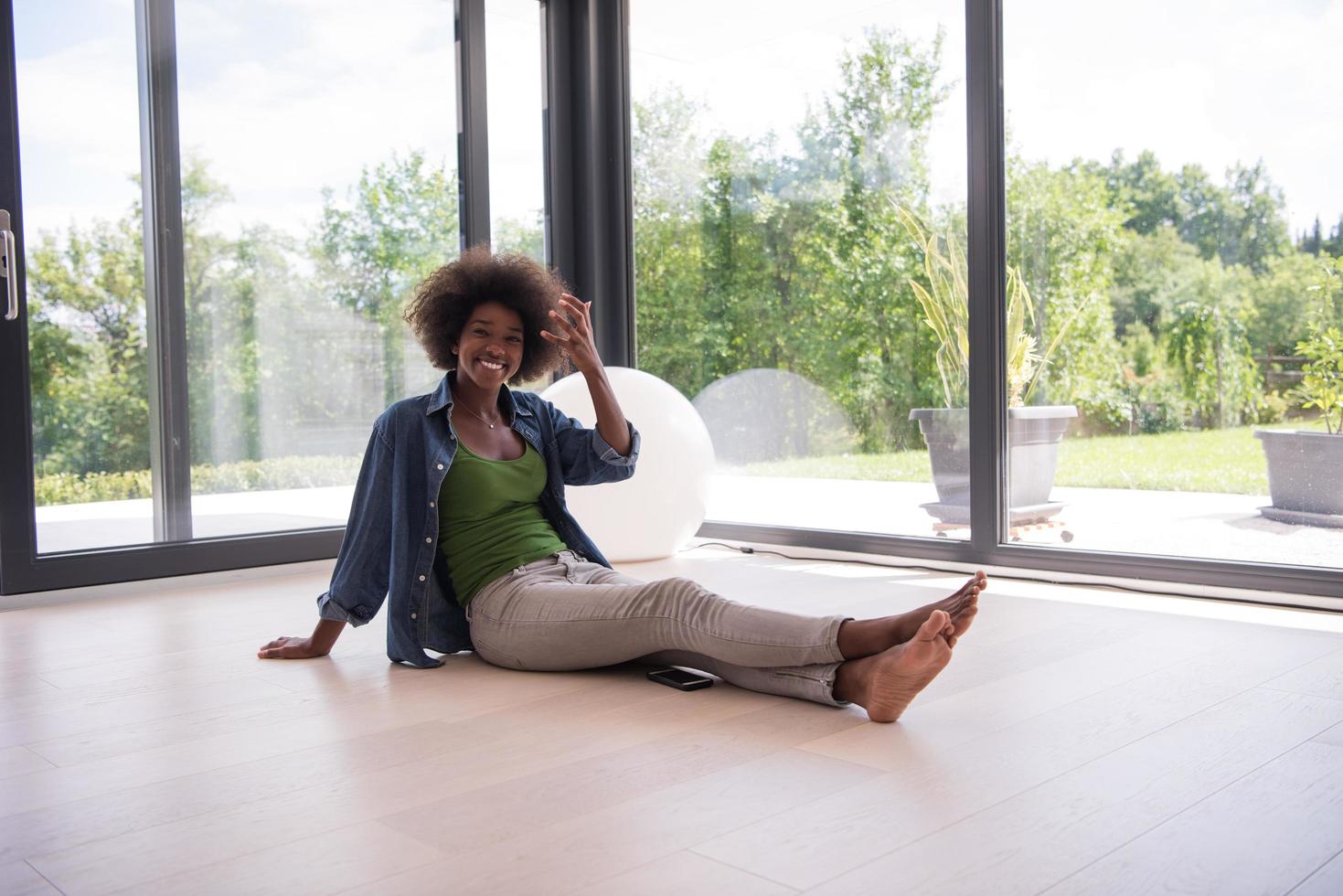 african american  woman  sitting near window photo