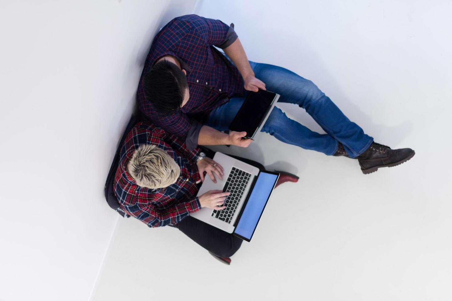 top view of  couple working on laptop computer at startup office photo