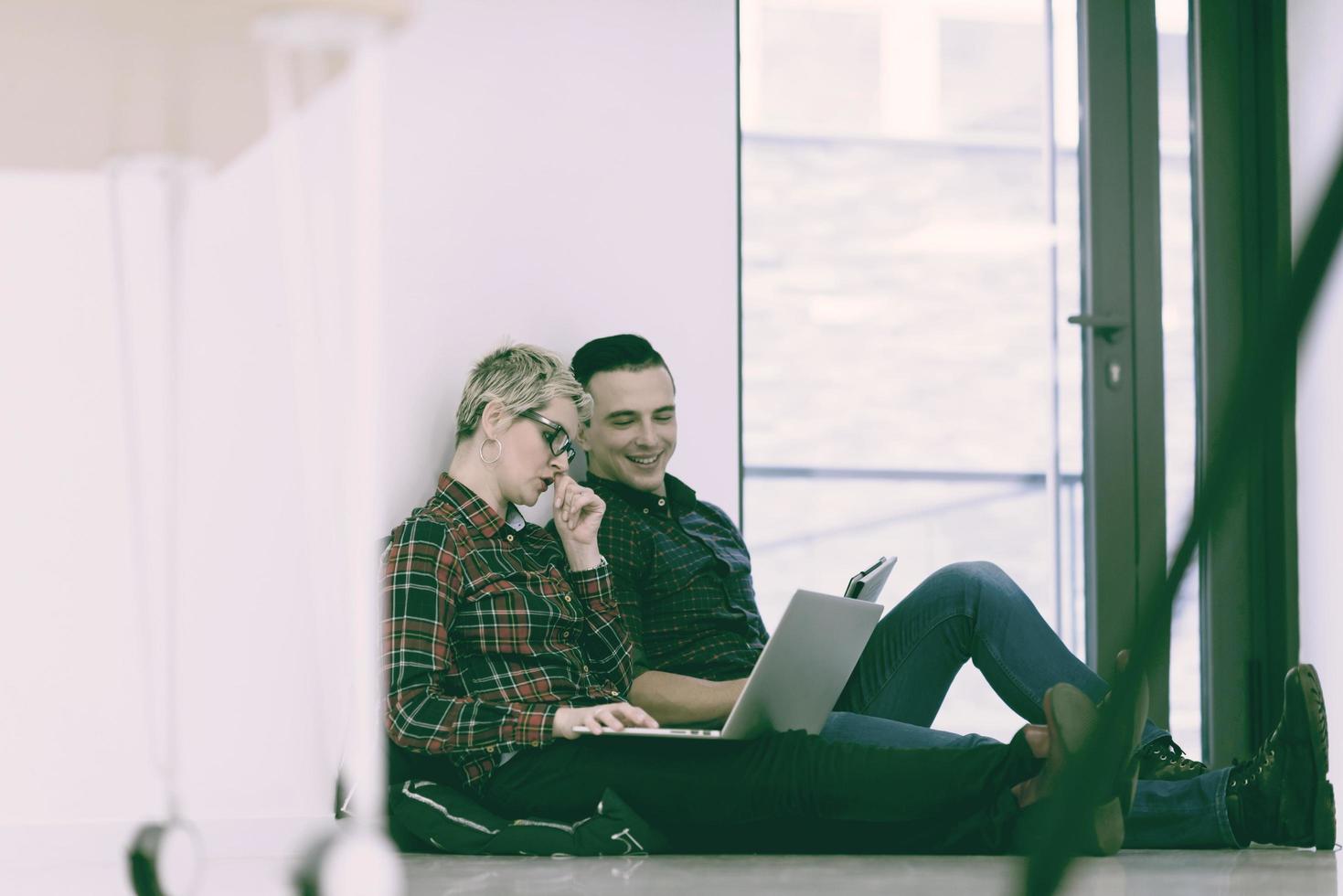 startup business, couple working on laptop computer at office photo