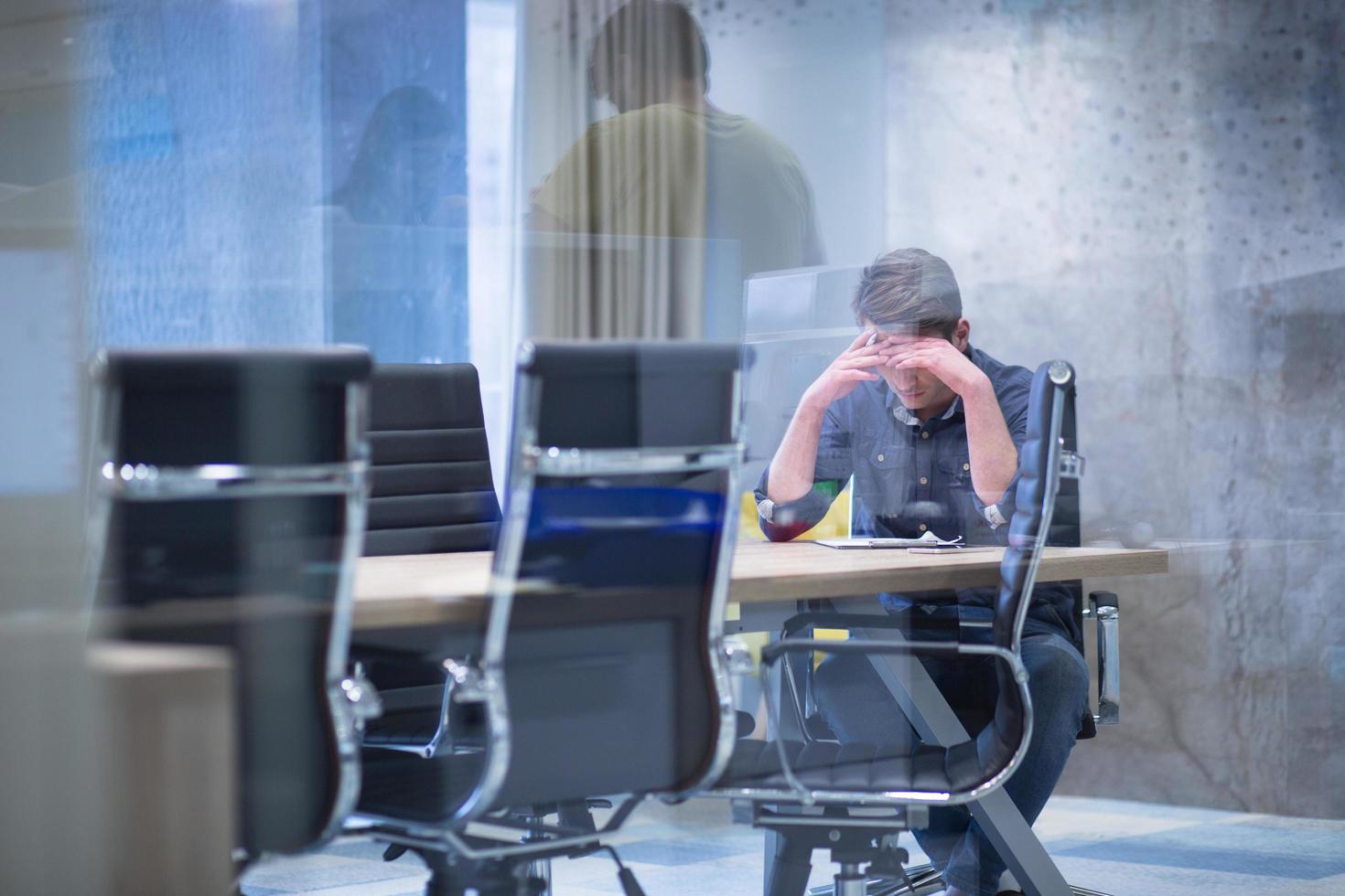 young businessman relaxing at the desk photo