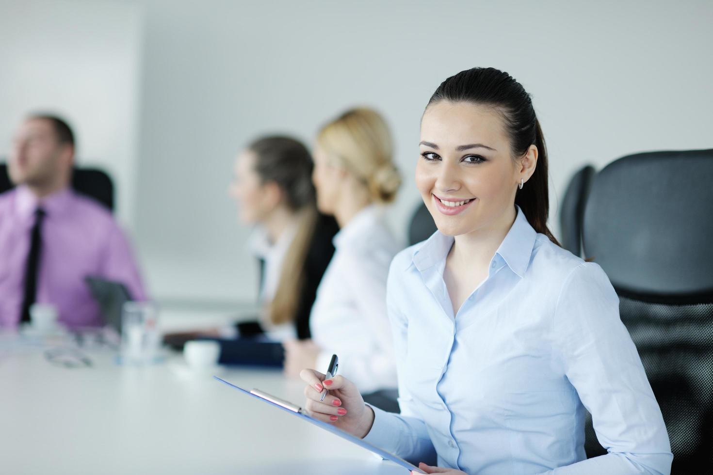 business woman standing with her staff in background photo