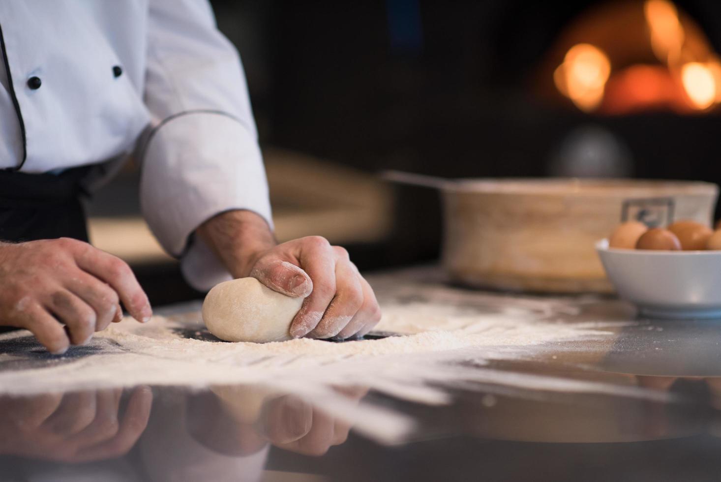 chef hands preparing dough for pizza photo