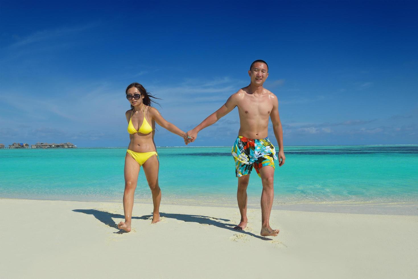 happy young  couple enjoying summer on beach photo