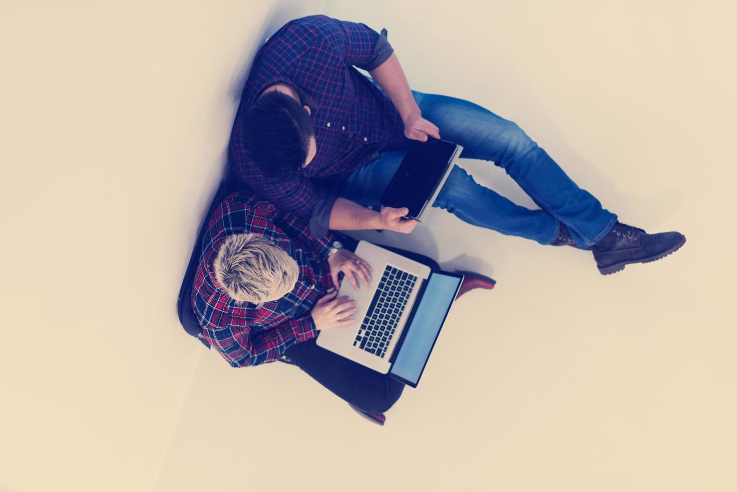 top view of  couple working on laptop computer at startup office photo