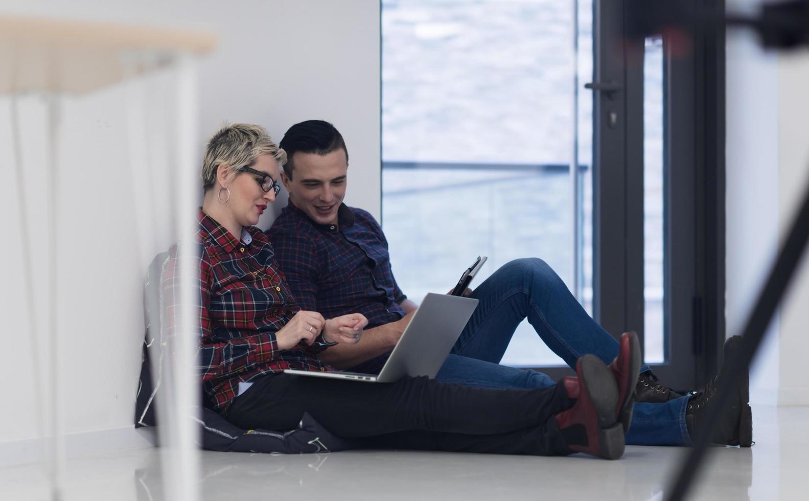 startup business, couple working on laptop computer at office photo