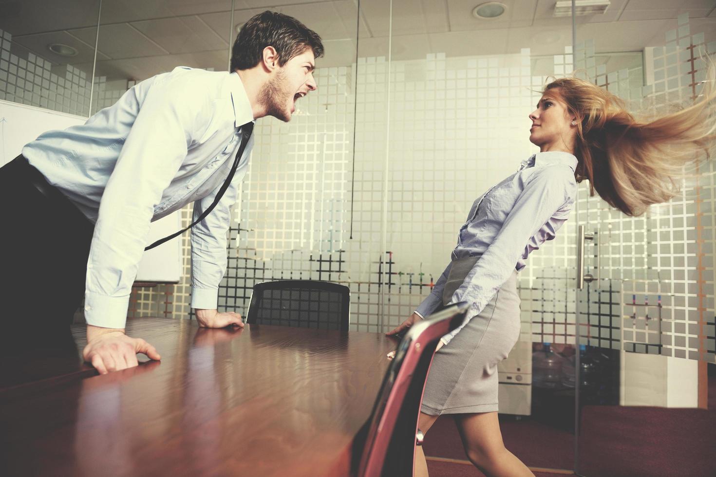 Angry busines sman screaming at employee photo